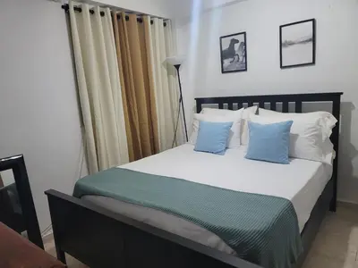 a bedroom with a bed with blue and white pillows at Fantastic apartment 1Rooms zona colonial in Santo Domingo