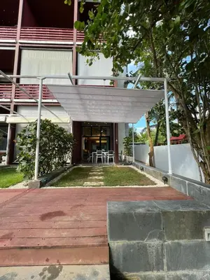 a porch of a building with a table and chairs at Aqua Loft 118 - Juan Dolio in La Puntica de Juan Dolio