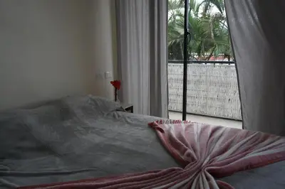 a bed in a bedroom with a large window at Yara-ri Apartaments in La Majagua