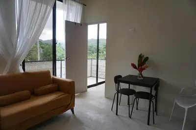a living room with a couch and a table with chairs at Yara-ri Apartaments in La Majagua