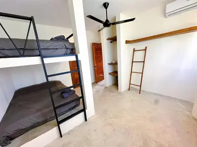 a room with two bunk beds and a ceiling fan at Casa Ola, luxurious jungle house in El Valle