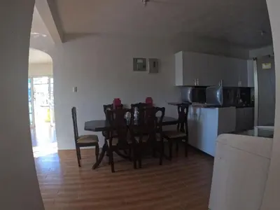 a kitchen and dining room with a table and chairs at Hotel Mi Propio Esfuerzo in Vicente Noble
