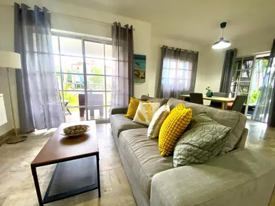 a living room with a couch and a table at Paradise Arenas De Bávaro RD in Punta Cana