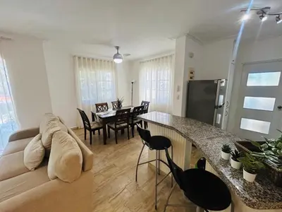 a living room with a couch and a table at Paradise Arenas De Bávaro RD in Punta Cana