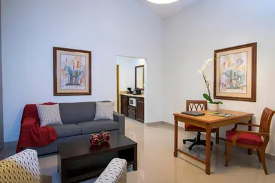 a living room with a couch and a table at Hodelpa Garden Suites - All Inclusive in Juan Dolio