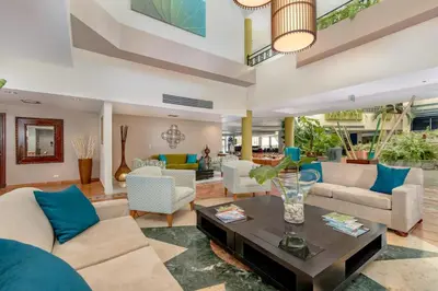 a living room with couches and a table at Hodelpa Garden Suites - All Inclusive in Juan Dolio