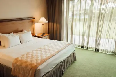 a hotel room with a bed and a window at Hodelpa Garden Suites - All Inclusive in Juan Dolio