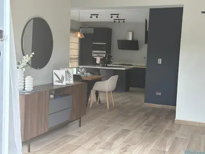 a kitchen with a desk and a table with a mirror at Ester house Sabaneta in Sabaneta
