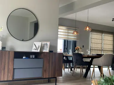 a dining room with a table and a mirror at Ester house Sabaneta in Sabaneta