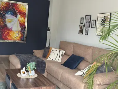 a living room with a couch and a table at Ester house Sabaneta in Sabaneta