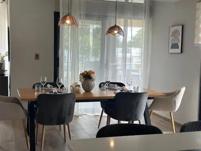 a dining room with a wooden table and chairs at Ester house Sabaneta in Sabaneta