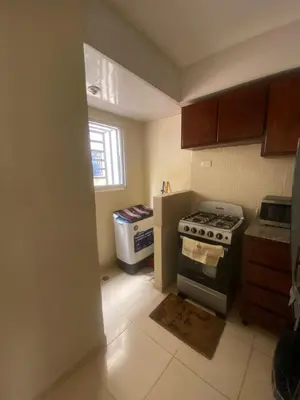 a small kitchen with a stove and a window at Como apartamento in La Javilla