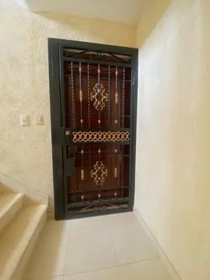 a metal gate in a room with stairs at Como apartamento in La Javilla