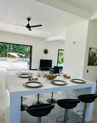 a kitchen with a table with wine glasses on it at Casa Juan Lucas in Las Galeras