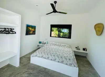 a bedroom with a bed and a ceiling fan at Casa Juan Lucas in Las Galeras