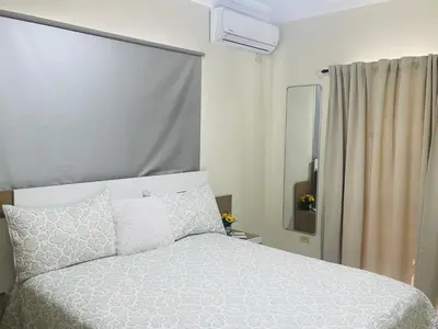 a bedroom with a white bed and a window at Villas Miranda in La Tentación