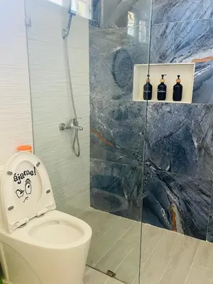a bathroom with a toilet and a glass shower at Villas Miranda in La Tentación