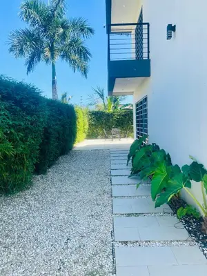 a pathway leading to a house with a palm tree at Villas Miranda in La Tentación