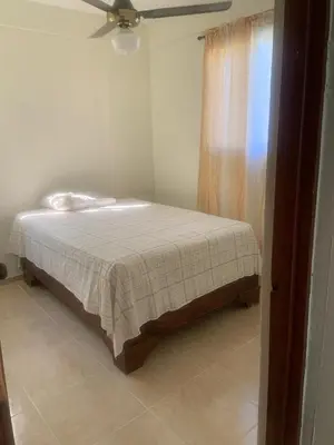 a bed in a room with a ceiling fan at Villa francia in Santa Cruz de Barahona