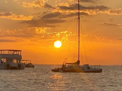 a sail boat in the water at sunset at Central in Punta Cana Beach Life RD in Punta Cana