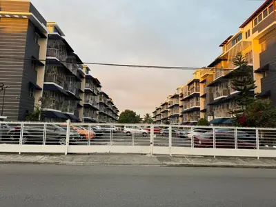 a row of apartment buildings next to a street with cars at Apartamento in Mendoza