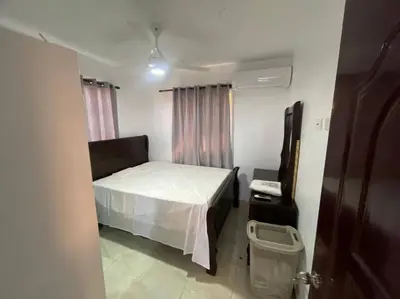 a small bedroom with a bed and a window at Villas Hillside apt 2 in Santa Bárbara de Samaná