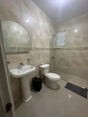 a bathroom with a sink and a toilet and a mirror at Casa de la presa in Monción