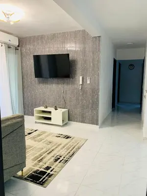 a living room with a television on a wall at Your Terrazas Del Este Getaway In La Romana in Cumayasa Kilómetros Diez