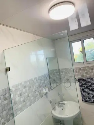 a bathroom with a sink and a glass shower at Your Terrazas Del Este Getaway In La Romana in Cumayasa Kilómetros Diez