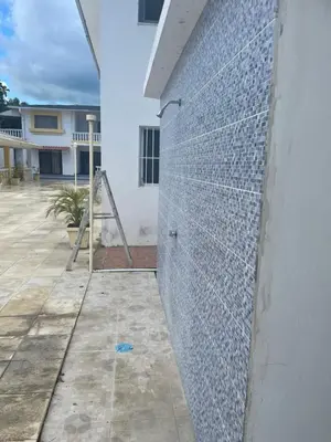 a wall of glass mosaic tiles on a building at Kasita del sol boca chica in La Caleta
