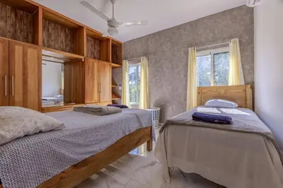 a bedroom with two beds and a mirror at Luxurious Home with Pool! in San Felipe de Puerto Plata