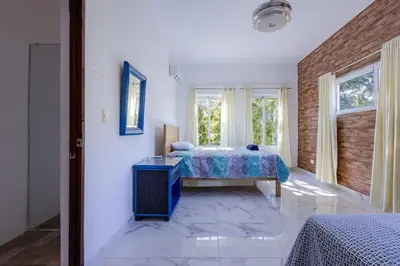 a bedroom with a bed and a window at Luxurious Home with Pool! in San Felipe de Puerto Plata