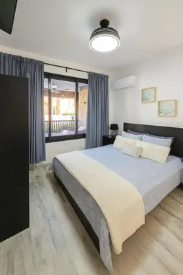 a bedroom with a large bed and a large window at Ocean Front Escape in Las Terrenas