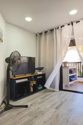 a living room with a fan and a television at Ocean Front Escape in Las Terrenas