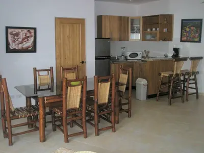 a kitchen with a table and some chairs and a counter at Lovely apartment by the Caribbean in Bayahibe