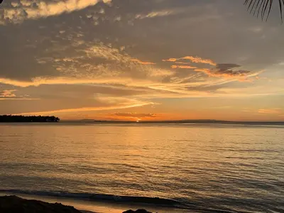 a sunset over a body of water at Beach Hotel Casa Nina in Las Terrenas