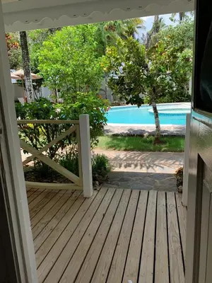 an open door to a porch with a pool at Beach Hotel Casa Nina in Las Terrenas