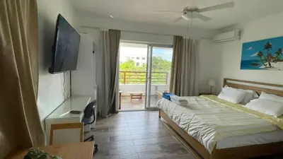 a hotel room with a bed and a television at Residencial Paraiso in Bayahibe