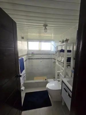 a bathroom with a tub and a toilet and a sink at Apartamento Playa Juan dolio in Villas del Mar