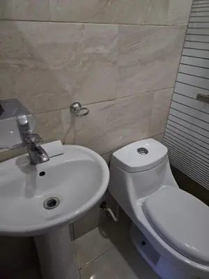 a bathroom with a white toilet and a sink at Full Department 2 hab in Las Terrenas
