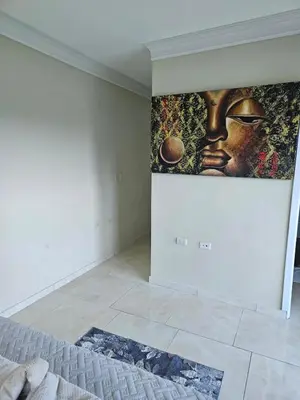 a bedroom with a painting on the wall at Full Department 2 in Las Terrenas