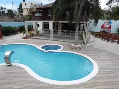 a large swimming pool in front of a house at villa cueva del padre pio in Santiago de los Caballeros