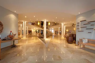 a large lobby with a staircase in a building at Penthouse Suite at Puerto Bahia in Samana in Los Grini