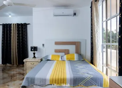 a bedroom with a bed and a window at Villas Hillside apt 3 in Santa Bárbara de Samaná