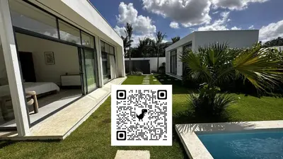 a house with a sign in front of a yard at 5 Bedroom Villa With Daily Housekeeping in Las Terrenas