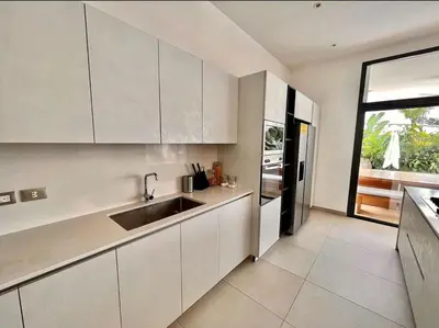 a kitchen with white cabinets and a sink at 5 Bedroom Villa With Daily Housekeeping in Las Terrenas
