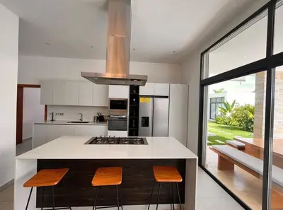 a kitchen with a island with a stove top oven at 5 Bedroom Villa With Daily Housekeeping in Las Terrenas