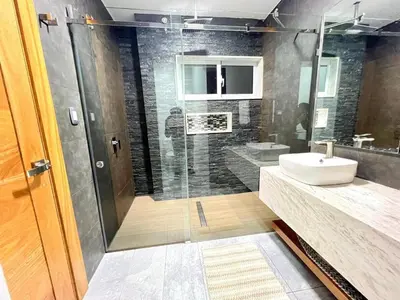 a bathroom with a glass shower and a sink at Modern and luxurious house in Santiago in Santiago de los Caballeros