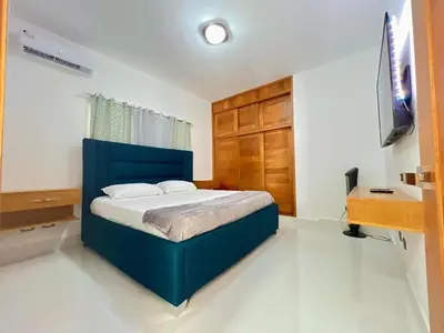 a bedroom with a blue bed and a desk at Modern and luxurious house in Santiago in Santiago de los Caballeros