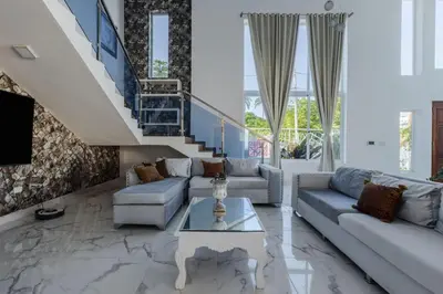 a living room with a couch and a table at Luxurious Home with Pool in San Felipe de Puerto Plata